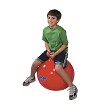 A school age boy bouncing on the Gymnic Super Hop 55 Spring Ball 