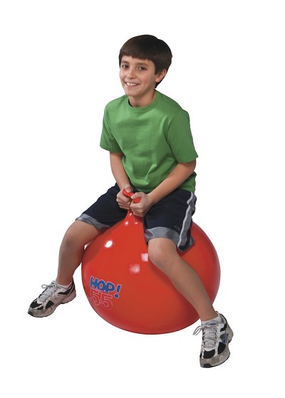A school age boy bouncing on the Gymnic Super Hop 55 Spring Ball 